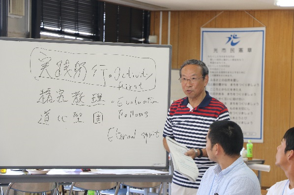 前に出て話す男性の写真