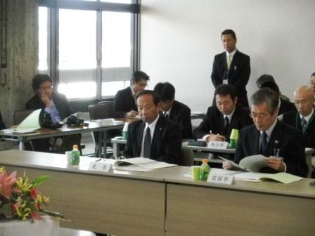 山口県市長会議にて市長が座ってテーブルに置かれた資料に目を通している写真