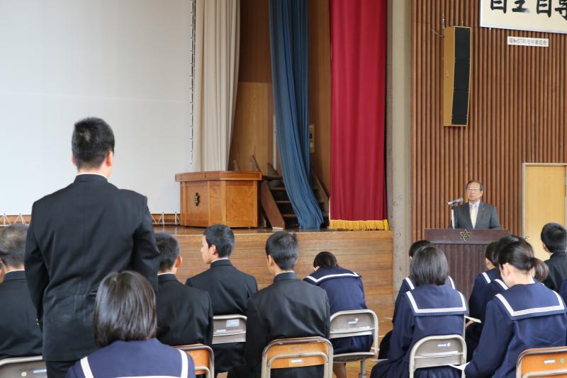 男子学生が起立して市長に質問をしている写真